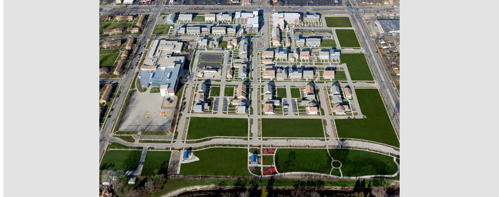 Low-altitude aerial photograph of Westlawn Gardens showing the midrise buildings at the top center and smaller residential buildings in the center; the Silver Spring Neighborhood Center and Browning Elementary School are on the left edge of Westlawn Gardens, and across the street are original Westlawn buildings.