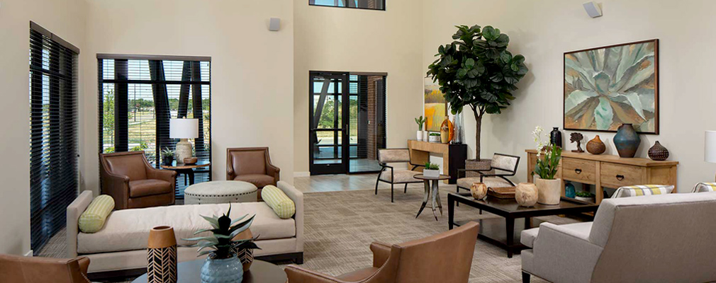 Photograph of a large room furnished with sofas, chairs, and tables.