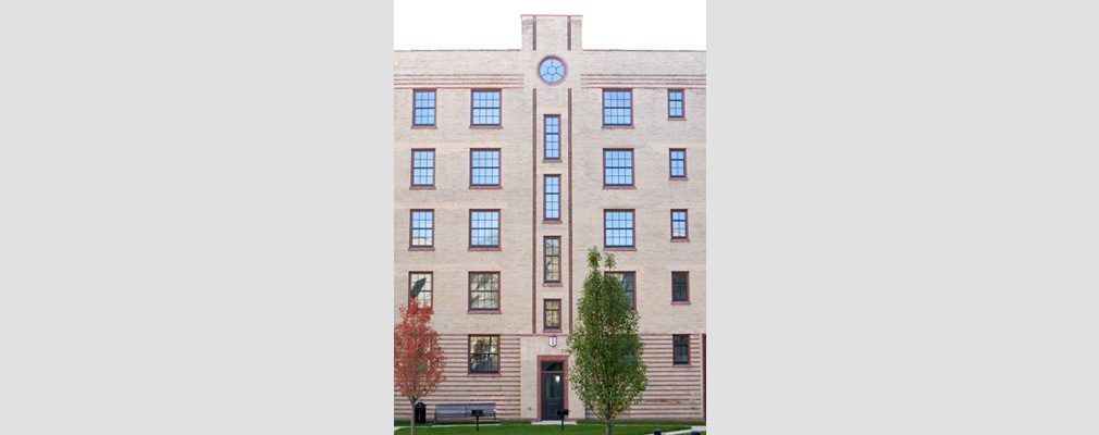 Photograph of one of the entrances to the five-story building from the courtyard.