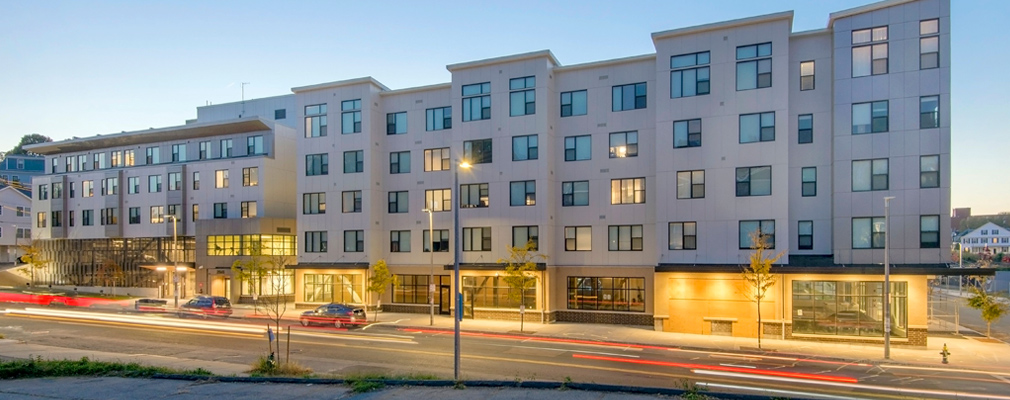 Photograph of the front façade of Building B, a five-story mixed-use building. 