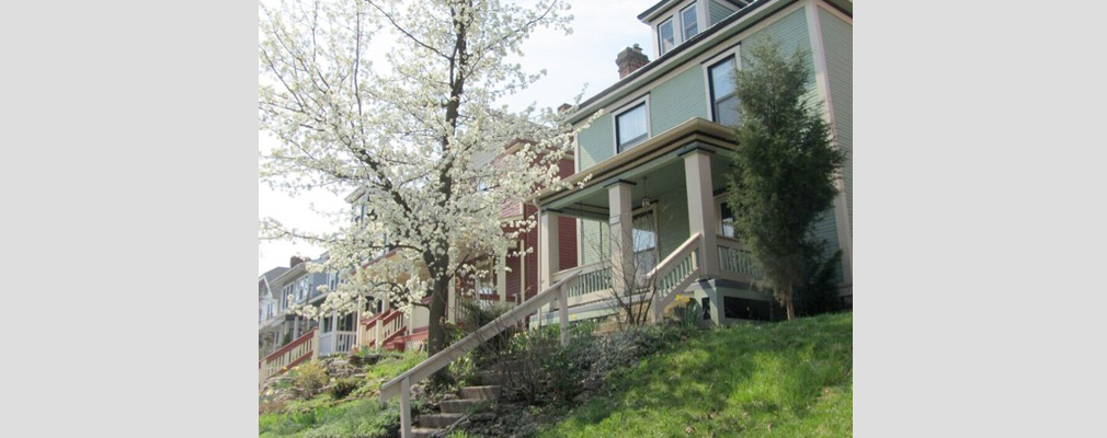 Photograph of several renovated two-story single-family houses.