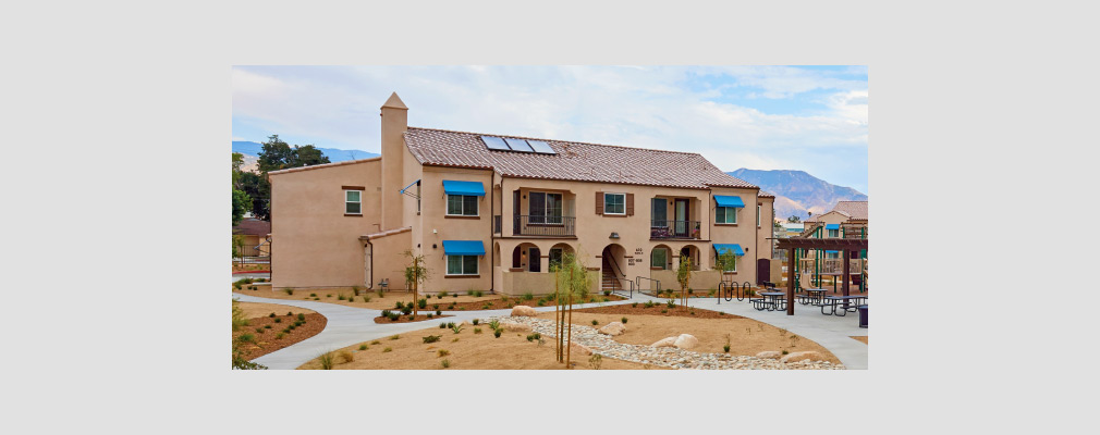 Photograph of the front façade of a two-story multifamily building. 