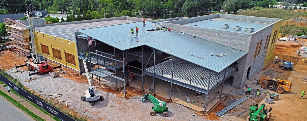 Low-angle aerial photograph of a multistory building under construction.