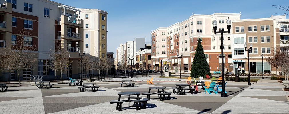Photograph of the plaza in the Town Square in the foreground and multistory buildings along Rowan Boulevard in the background.
