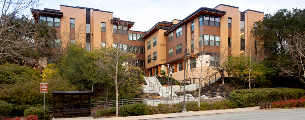 Photograph of the façade of a multistory multifamily building.