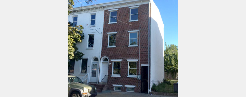 Photograph of a renovated three-story rowhouse.