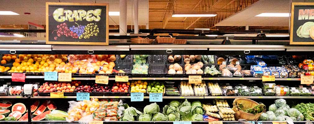 Photograph of fresh produce in a refrigerated case inside a supermarket. 