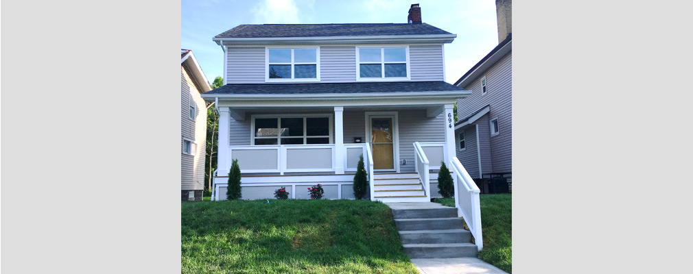 Photograph of the front façade of a newly renovated two-story detached house.