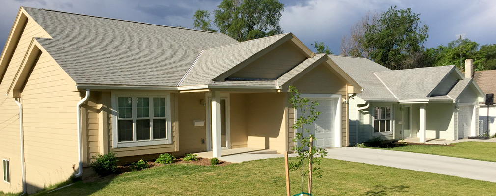 Photograph of two newly constructed single-family detached houses.  