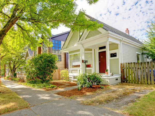 Photograph of two sides of a small single family home.