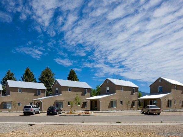 Photograph of five 2-story, single-family detached houses.