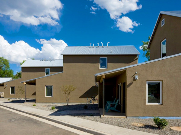 Photograph showing the sides of three 2-story, single-family detached homes.