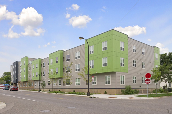 Photograph of the front and side façades of a three-story mixed use building.