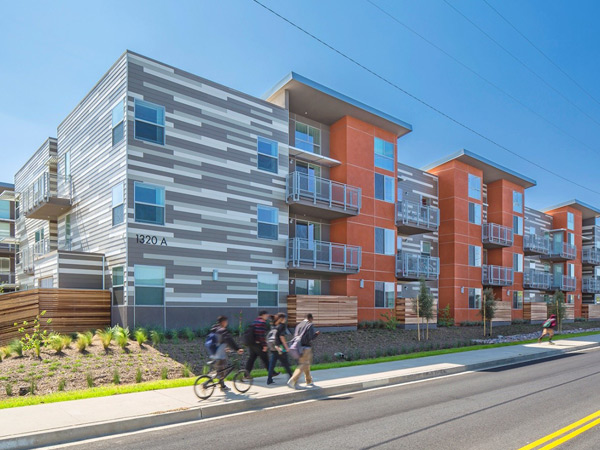 Photograph of three 3-story multifamily buildings.