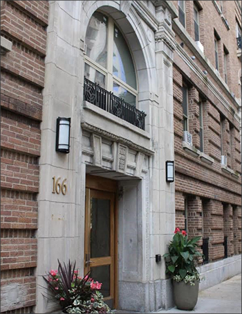 Photograph of the entryway to a multistory brick building. 