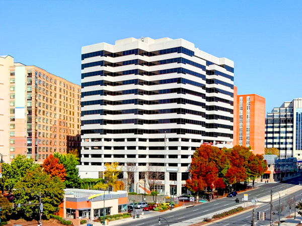 Image of several multistory buildings along a divided road. 