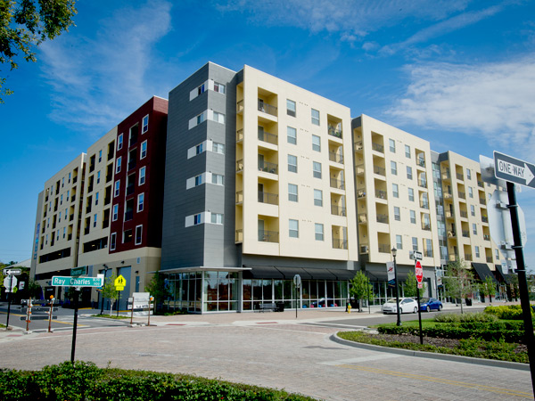 Photograph showing two sides of a multistory residential building at the intersection of Ray Charles Boulevard and Governor Street in Tampa, Florida.