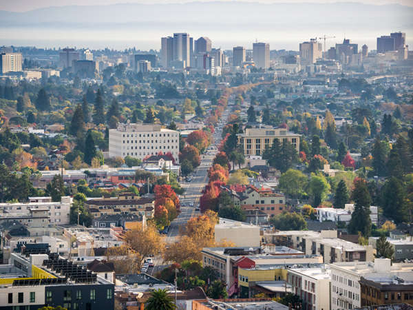 Aerial image of downtown Oakland, California, with the University of Berkeley campus visible in the foreground.