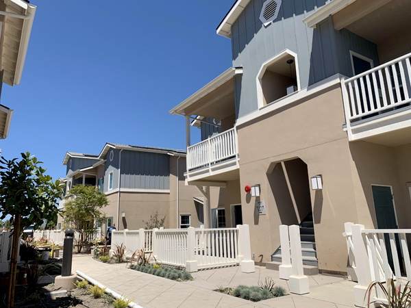 Image of two-story apartment buildings around a courtyard.