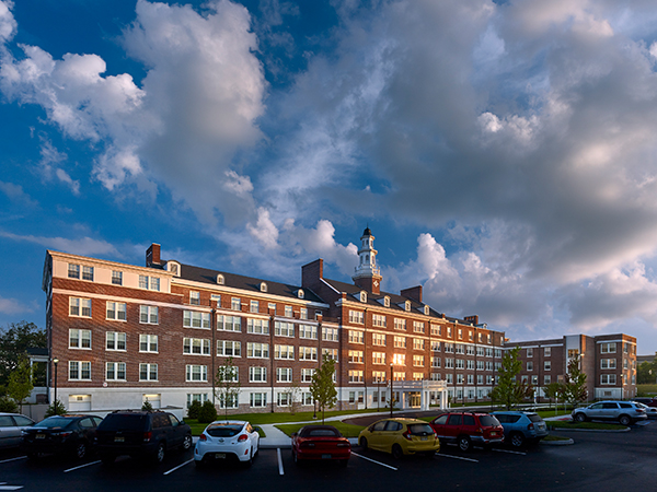 A photograph of a six-story brick building.