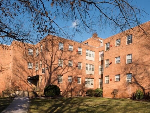 A three-story, brick residential building.