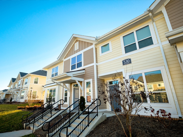 A two-story townhome on a residential street.