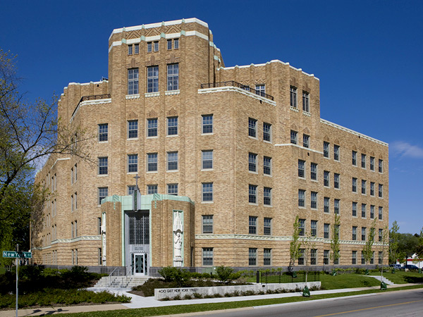 A six story brick building with art deco ornamentation occupying a corner lot.
