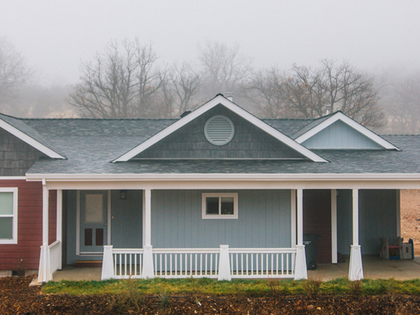 A single-story house with a front porch and a carport.