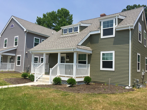 Photograph of a single family home and an adjacent duplex.