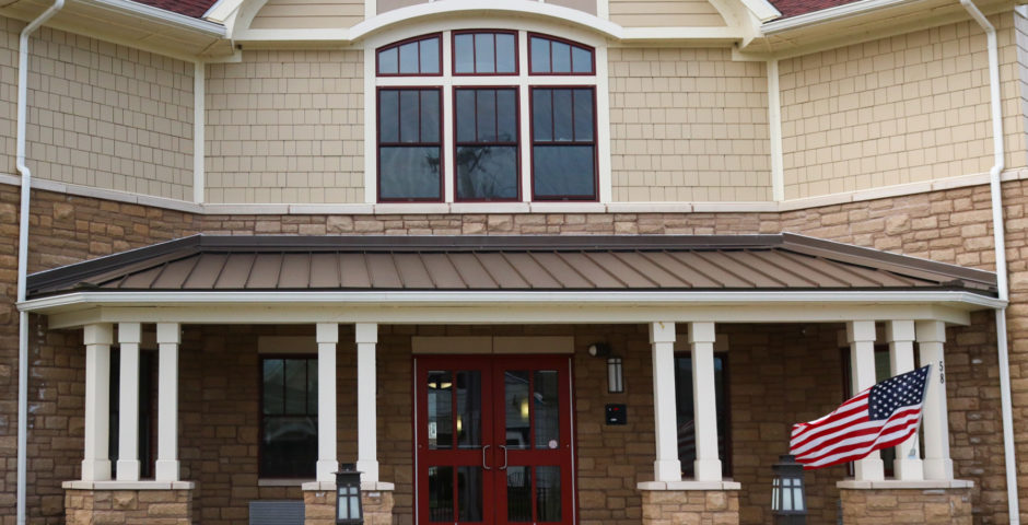 Image showing the façade of the Hope Gardens development, a two story building clad in stone and siding.