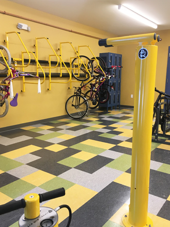 A bike storage room with racks and pumps for bicycles.