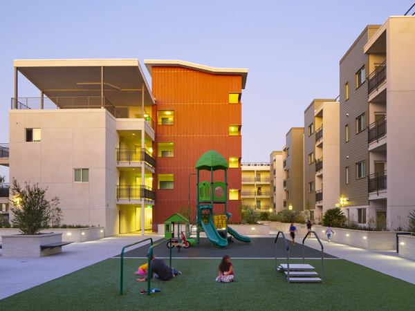 An outdoor courtyard and playground for an apartment complex.