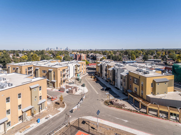 Aerial photograph of several three-story apartment buildings.