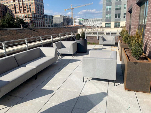 Photograph of an outdoor terrace with seating and planters.