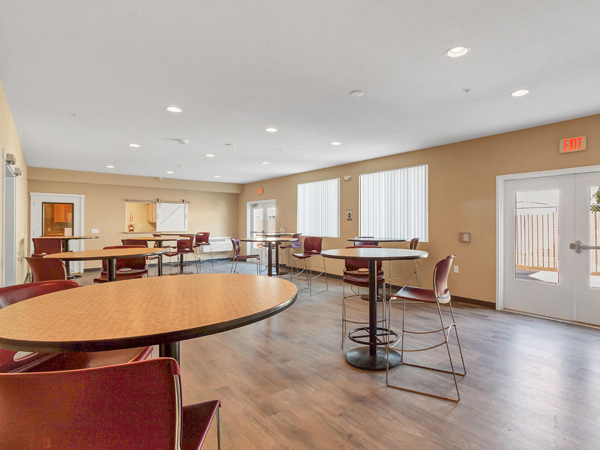 An image of a room with several tables and chairs.