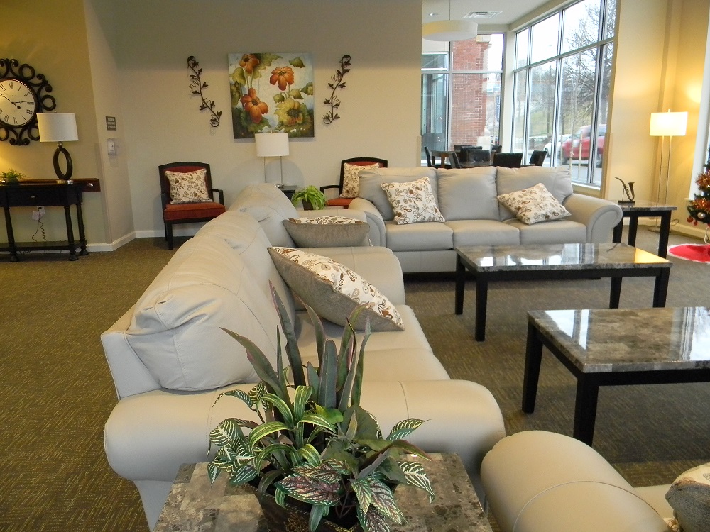 An interior lounge furnished with plush couches surrounding coffee tables.