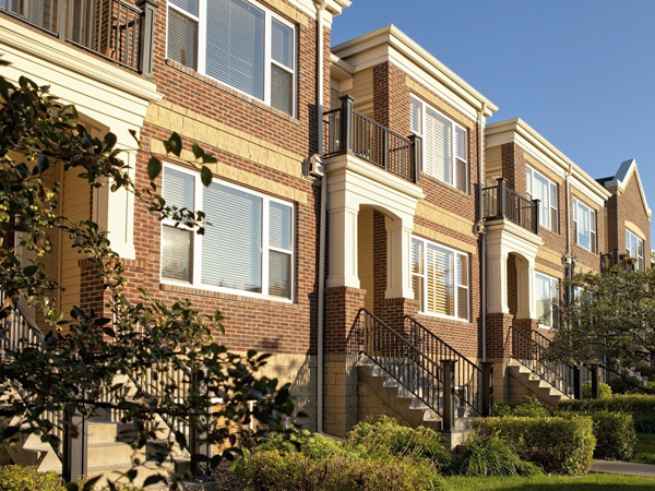 Photograph of low-rise residential buildings with stairways leading down to the street.