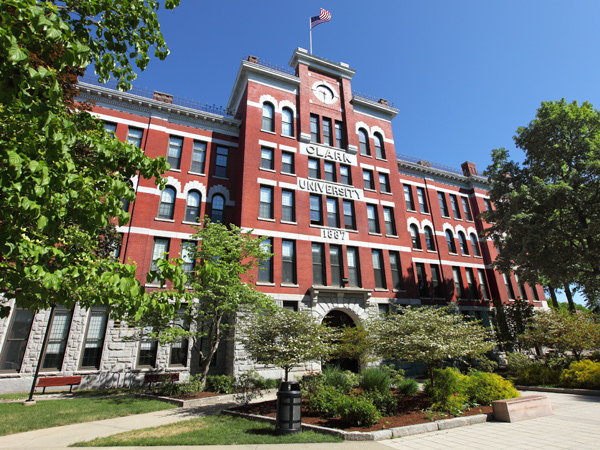 Jonas Clark Hall, a multistory stone and brick building with an arched entrance, on the Clark University campus.