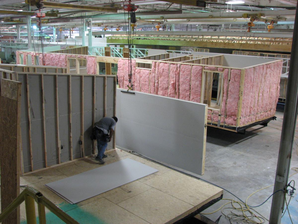 Image of a worker constructing a modular home.