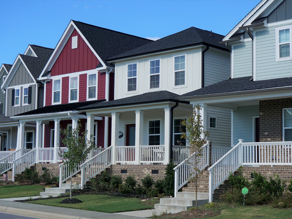 Photo of multiple buildings with facades of brick and siding.