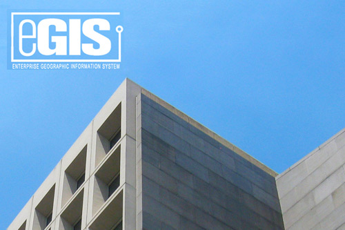 Image of a corner of the Robert C. Weaver Federal Building (HUD Headquarters) with the eGIS logo superimposed.