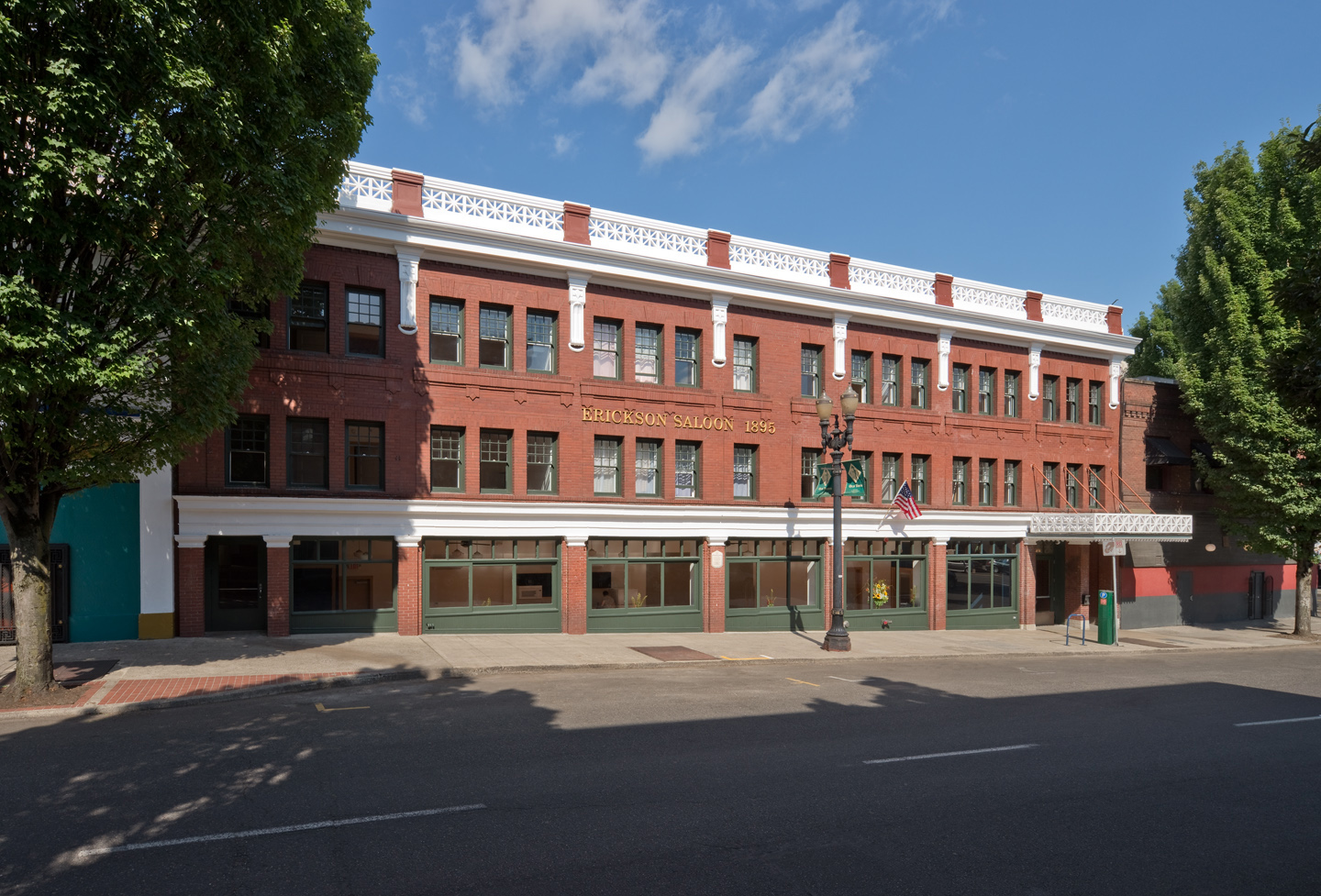 Photograph of the front façade of a three-story red-brick building.