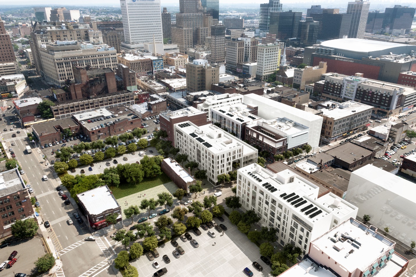 Low-angle aerial photograph of midrise buildings in the foreground, with high-rise buildings in the middleground. 