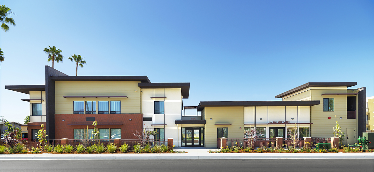 Wide-angle photograph of a two-story multifamily building. 