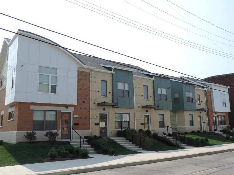 Photograph of the front façades of five two-story, attached houses. 