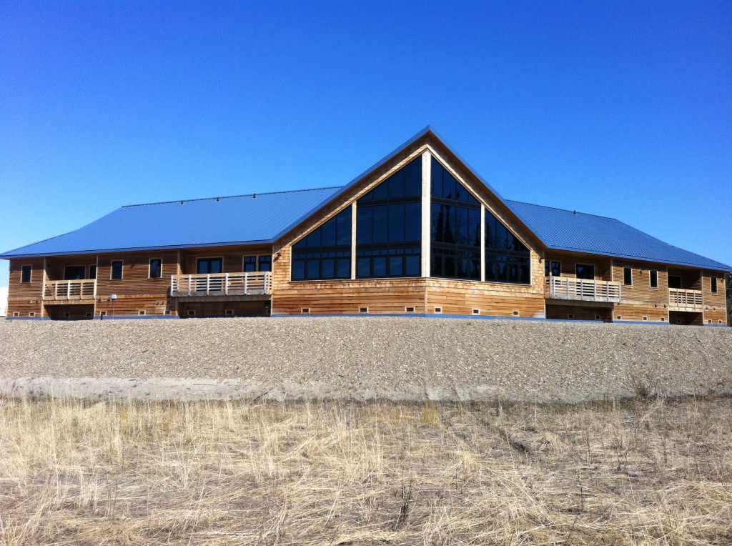 Photograph of a one-story building with wood siding.