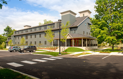 Photograph of the exterior of a three-story multifamily apartment building.