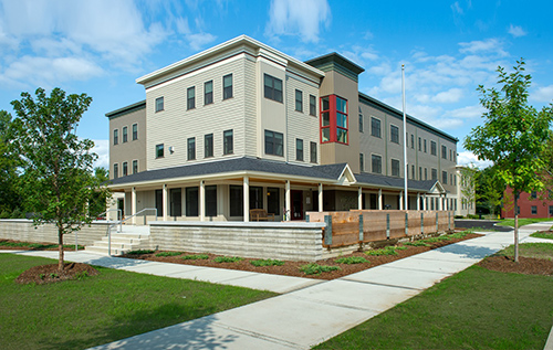 Photograph of the exterior of a three-story multifamily apartment building.