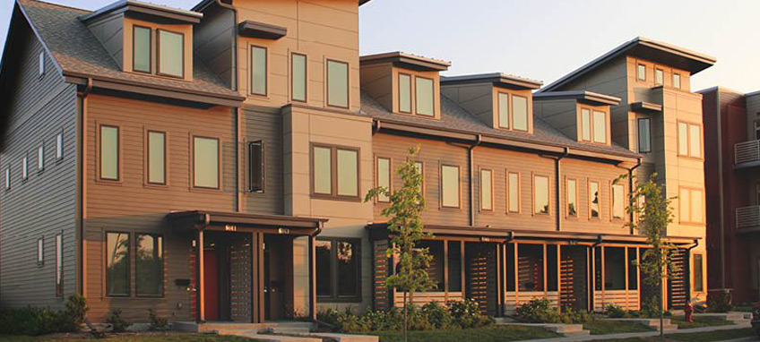 Multi-story, attached dwelling units with porches. 