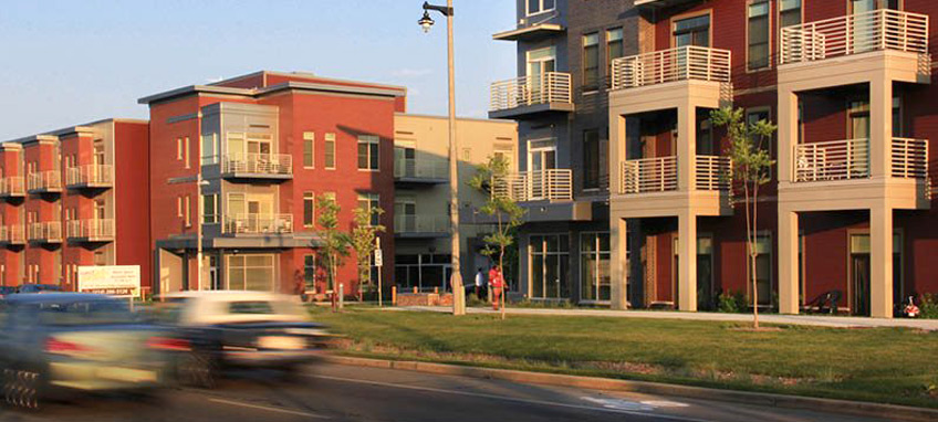 Two multi-story residential buildings along a street.